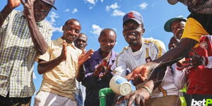 betPawa winner Rophus together with his community members around a water point.