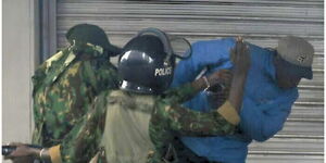 Police officers assaulting mask vendor Boniface Kariuki at Imenti House during protests on June 17, 2025.