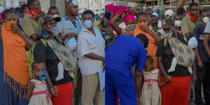 A collage of Susan Kageya and her child with plastic bottle mask (l) Kageya and her child receive proper facemasks from Coast Regional Police Boss Yakub Rashid.  