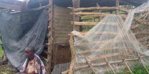 Mama Dorina at her house that had nylon for walls.