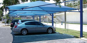 Cars parked under a car shade in an estate in Nairobi County.