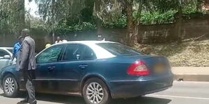 A police officer standing next to the vehicle which hit a pedestrian along Kipande Road in Nairobi on April 20, 2023.