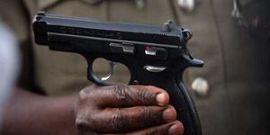 A file image of a police officer holding a pistol