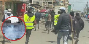 A group of residents scampering for safety after police officers lobbed tear gas canisters during a violent confrontation in Kariobangi North on Sunday, November 30, 2025.