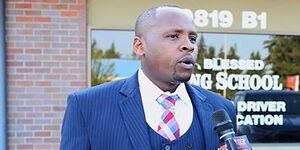 Blessed Driving school founder, Charles Kamau (left) addresses the media in Washington State, USA.