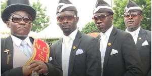 The dancing pall-berarers fully dressed in their work regalia.