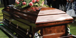 A casket being lowered into the ground