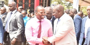 Comedian MC Jessy shaking President William Ruto's hand at Kirubia Stadium on March 12, 2023