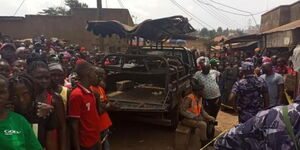 A file photo of  Ugandan police and residents at a crime scene in Uganda