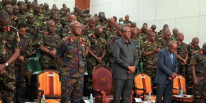 Defence CS Aden Duale poses for a photo with the Chief of Defence Forces (CDF) Francis Ogola and KDF soldiers.