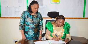 Pastor Dorcas Rigathi signing the visitor's book at Alliance Girls High School on Sunday, June 25, 2023.