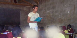 A photo of Daniel Radcliffe teaching in Kenya on a volunteer trip overseas. 