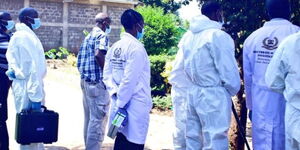 Directorate of Criminal Investigation (DCI) detectives probe a crime scene in Nairobi on January 14, 2020. 