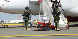 DCI officers during a sting operation on a plane at the Jomo Kenyatta International Airport (JKIA) in June 2019