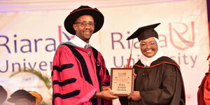 Riara University Vice Chancellor, Prof Robert Gateru, poses for a photo with Deka Rashid Ibrahim at the institution’s 7th Commencement held on Friday, July 14, 2023. She was also awarded the Vice Chancellors Roll of Honour for top Law student of 2023.