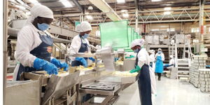 Employees working at Del Monte fruit processing plant