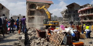 A bulldozer brings down a building in Kayole estate in 2018.