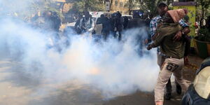 Police lobby tear gas at hundreds of people protesting near parliament on Tuesday, June 6, 2023.