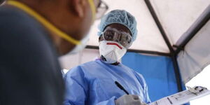 Laboratory technician attends to a patient seeking a corona virus test at Lancet Kenya laboratory in Nairobi, Kenya, on Sunday, April 5, 2020.