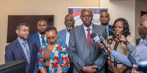 Dr. Erick Rutto, (center) President of Kenya National Chamber of Commerce and Industry (KNCCI) during an interview