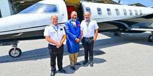 Prophet David Owuor (centre) with two pilots in Rio de Janeiro, Brazil.