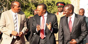 President Uhuru Kenyatta (centre) with Deputy President William Ruto (right) and Majority Leader Aden Duale at Jomo Kenyatta International Airport on January 29, 2014.