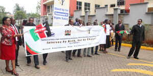 KHRC members holding a banner 