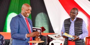 Education CS Ezekiel Machogu (left) and President William Ruto.