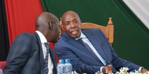 Education CS Ezekiel Machogu (right) and his PS Belio Kipsang.