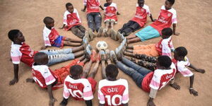 Lawrence Masira, and his friends wearing new Arsenal jerseys with the label “Ozil 10” 