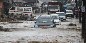 Vehicles navigate a flooded road in Mombasa.