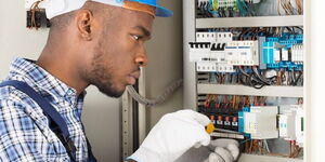 A file image of a Kenyan electrician at work.