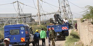 KPLC workers repair a collapsed transmission tower in Nairobi on January 11, 2022.