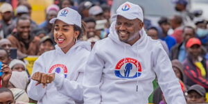 Entrepreneur Faith Mwaura (left) and Trade CS Moses Kuria (right) atop a vehicle during campaigns in 2022