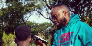 Entrepreneur James Ngare alias Barber Wa Taifa giving a haircut in Nakuru on September 2022
