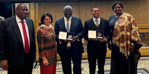 Manoah Esipisu, center, shows off his award at the London Diplomat awards on April 22, 2024