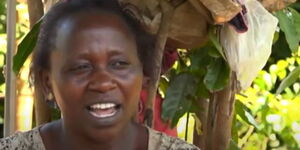 Esther Nyaguthii, a mother of five, who has been living under a tree with her children.