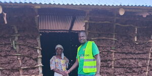 Eugen Otieno handing over a house to a widow In Busia in a past event.