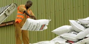 An image of an NCPB employee handling fertiliser in a warehouse in 2021.
