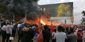 Passers-by watch as fire razes businesses at City Stadium, Nairobi on Tuesday, January 30, 2024