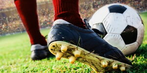 Stock image showing a footballer about to kick a ball