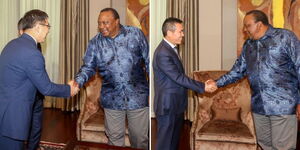 Former President Uhuru Kenyatta greets Chinese Ambassador Zhou Pingjian.