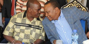 Former President Uhuru Kenyatta (right) speaks to William Kabogo