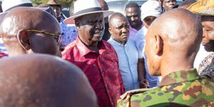 Former Prime Minister Raila Odinga (in maroon shirt) confronts a police officer in Narok.