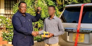 An image depicting COTU Secretary General Francis Atwoli gifting a young man a car.