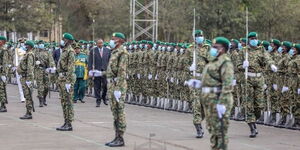 Former President Uhuru Kenyatta inspecting a guard of honour during the pass-out parade of 9,464 NYS graduates at the Gilgil Training College on June 10, 2022.