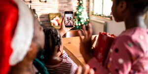 Young family on a video call with their grandparents 