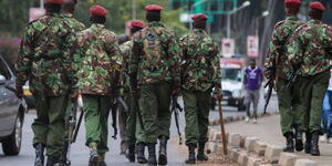 A contingent of General Service Unit (GSU) Police officers walking by the roadside