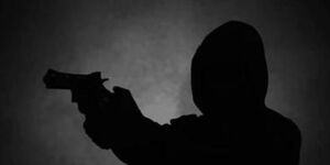A silhouette image of a man wielding a gun