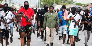 Members of a gang in Haiti carrying guns on the streets